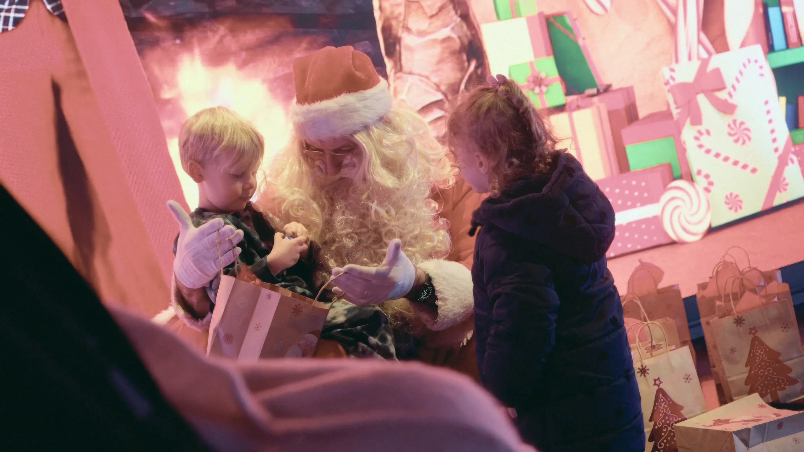 Father Christmas handing a gift to a child