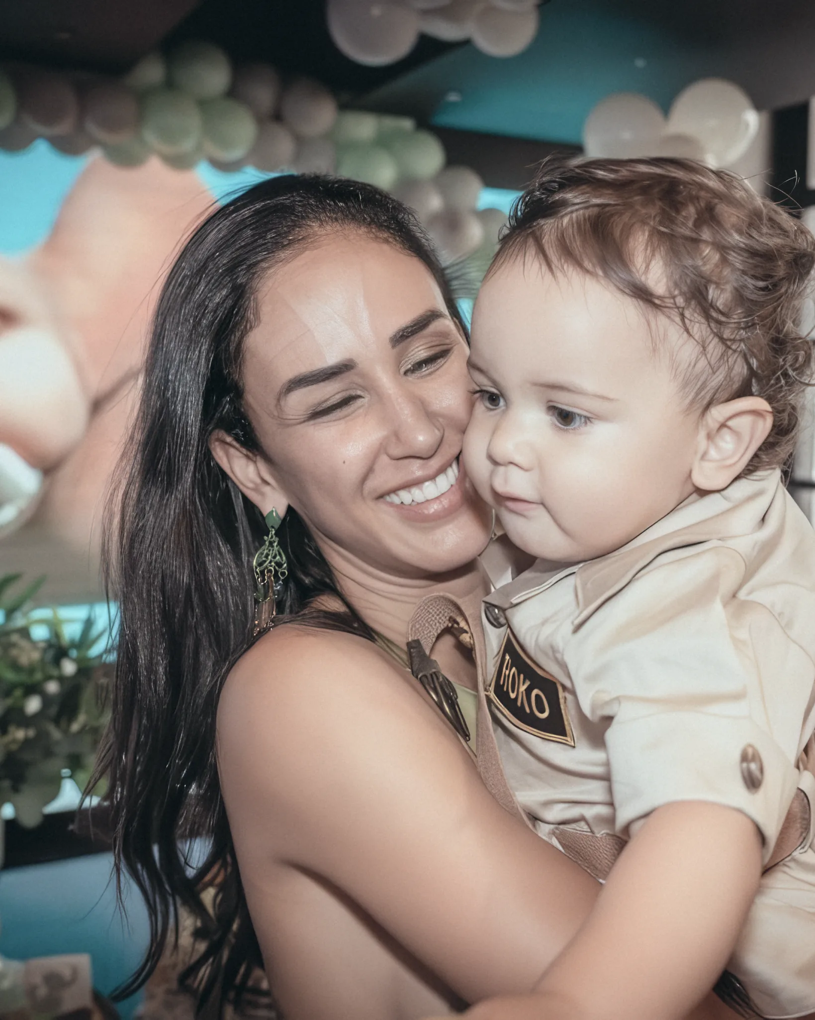 Maria holding her son Rocco and laughing